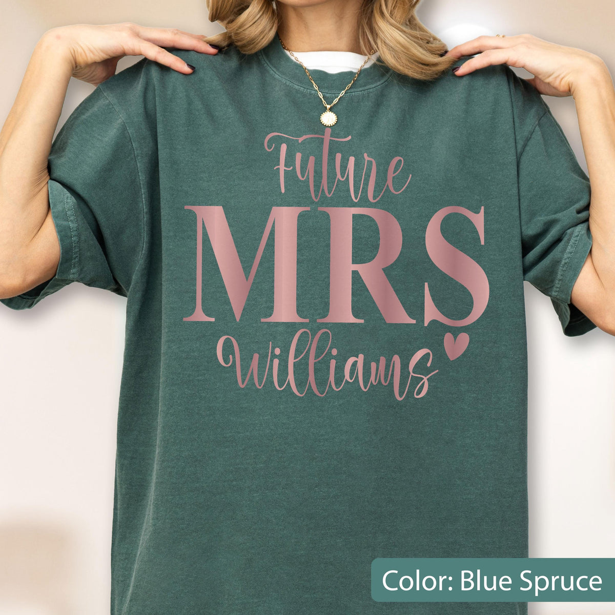 May include: A blue spruce short-sleeve t-shirt featuring the text Future MRS Williams in a metallic rose gold font. The word Future is written in a cursive script above the large block letters MRS, followed by the name Williams and a small heart.