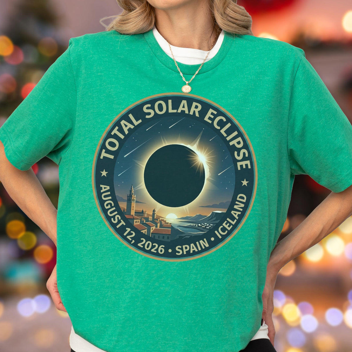 May include: A bright green short-sleeve t-shirt featuring a circular graphic of a total solar eclipse. The text reads Total Solar Eclipse, August 12, 2026, Spain, Iceland. The design shows a dark moon silhouette over a coastal town landscape.