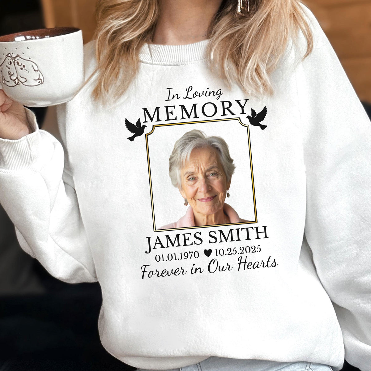 May include: A white crewneck sweatshirt featuring a memorial graphic with the text In Loving Memory, the name James Smith, dates 01.01.1970 and 10.25.2025, and the phrase Forever in Our Hearts, centered around a portrait of an older person with two black birds.