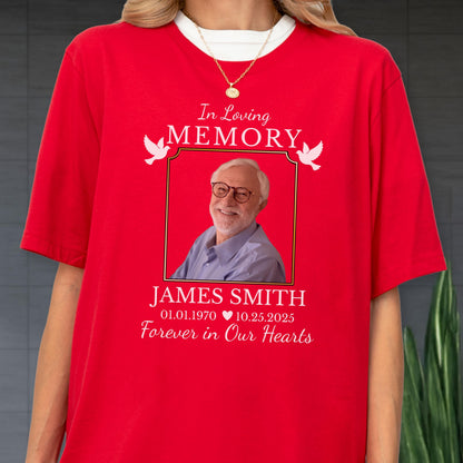 May include: A bright red short-sleeved t-shirt featuring a memorial graphic. The design includes the text In Loving Memory, a photograph of an older person with glasses, the name James Smith, dates 01.01.1970 to 10.25.2025, and white doves.