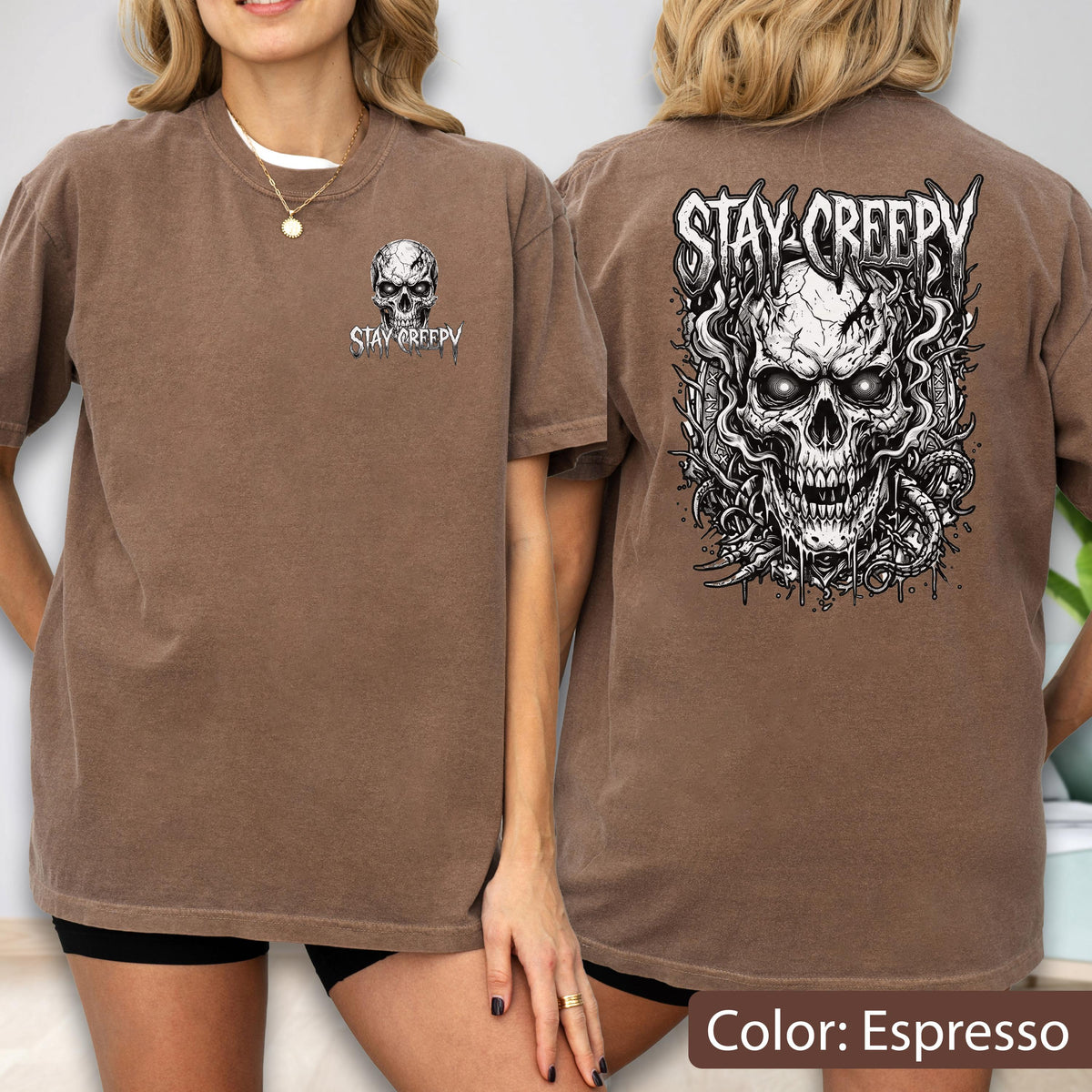 May include: An espresso brown t-shirt featuring a small skull graphic on the front left chest with the text STAY CREEPY. The back displays a large, detailed black and white illustration of a skull surrounded by swirling smoke and vines.
