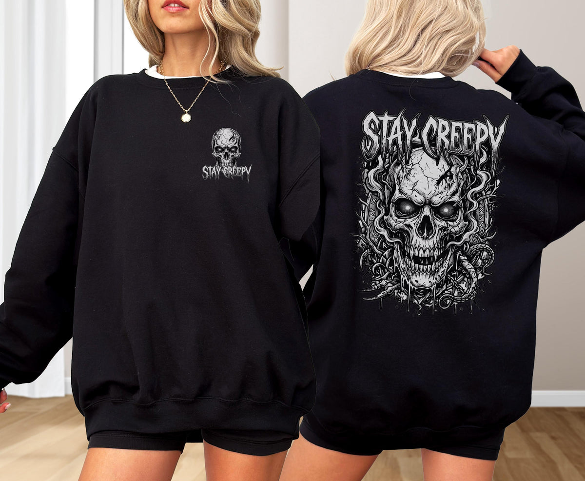 May include: A black crewneck sweatshirt featuring a small white skull graphic and the text "STAY CREEPY" on the front left chest, and a large, detailed white skull illustration with the text "STAY CREEPY" printed on the back.