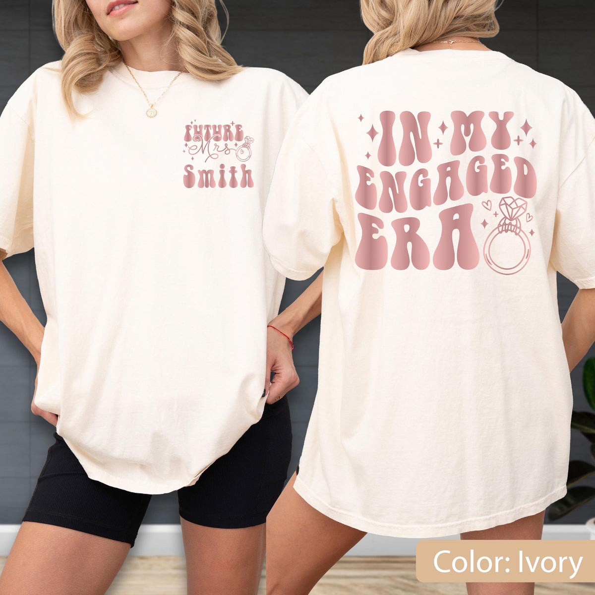 May include: An ivory short-sleeve t-shirt featuring pink text and graphics. The front displays "Future Mrs. Smith" with a small ring icon. The back features the large text "IN MY ENGAGED ERA" in a wavy font, accompanied by a diamond ring illustration.