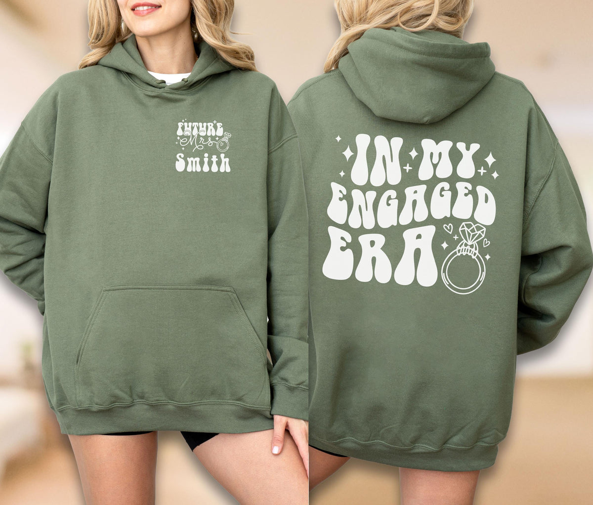 May include: An olive green hooded sweatshirt featuring white text on the front left chest reading Future Mrs. Smith with a ring icon. The back displays the large white text IN MY ENGAGED ERA with a diamond ring graphic and small star accents.