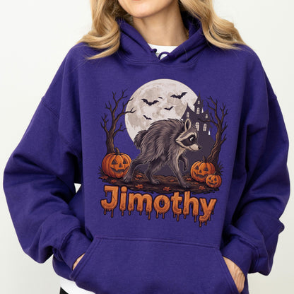 May include: A deep purple hooded sweatshirt featuring a graphic print of a raccoon standing in front of a full moon, a haunted house, bare trees, and jack-o'-lanterns. The name Jimothy is printed in orange, dripping-style lettering below the graphic.