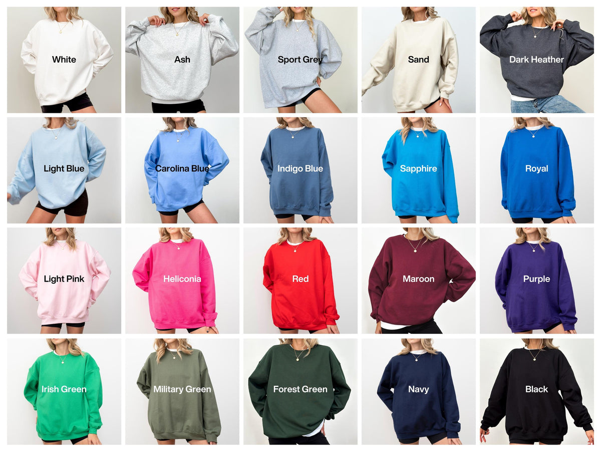 May include: A collection of twenty crewneck sweatshirts in various solid colors including white, ash, sport grey, sand, dark heather, light blue, carolina blue, indigo blue, sapphire, royal, light pink, heliconia, red, maroon, purple, irish green, military green, forest green, navy, and black.