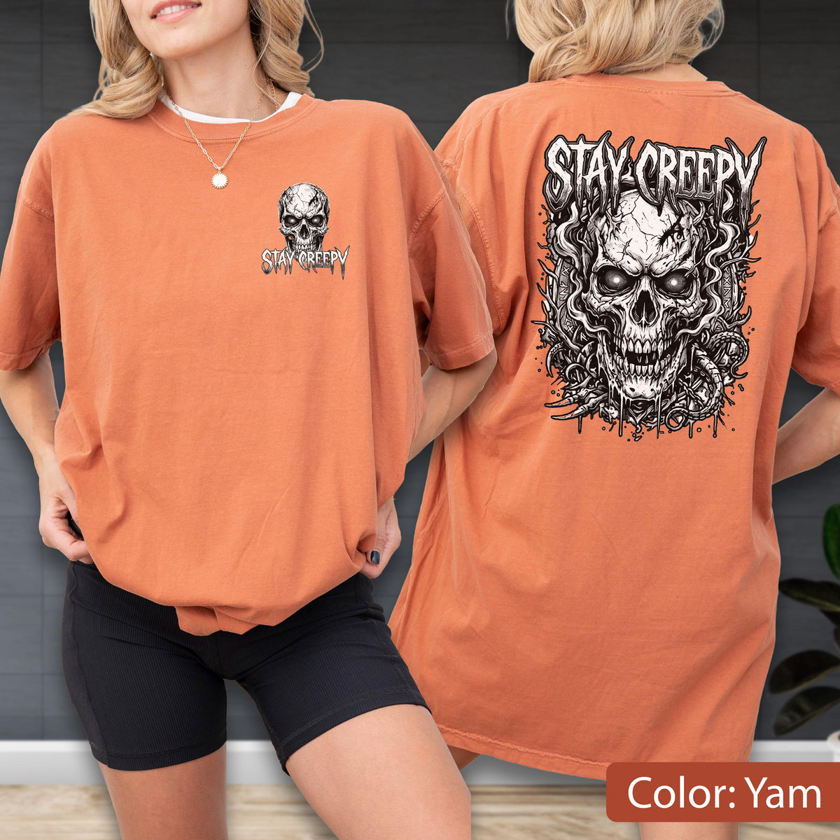 May include: A yam-colored t-shirt featuring a small skull graphic on the front left chest and a large, detailed black and white skull illustration on the back, both accompanied by the text "STAY CREEPY" in a stylized, jagged font.
