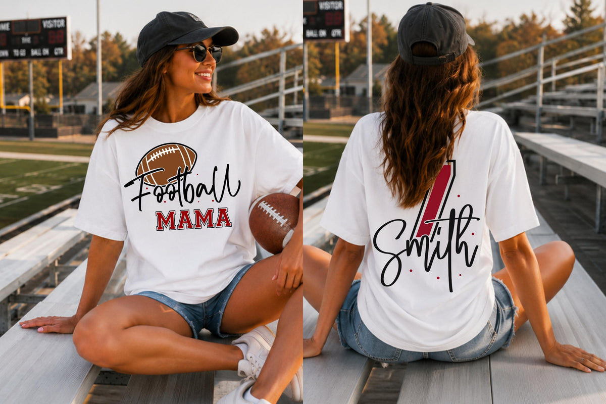 May include: A white short-sleeve t-shirt featuring a brown football graphic with the text Football MAMA on the front and the name Smith with a red number one graphic on the back, paired with blue denim shorts and a dark gray baseball cap.