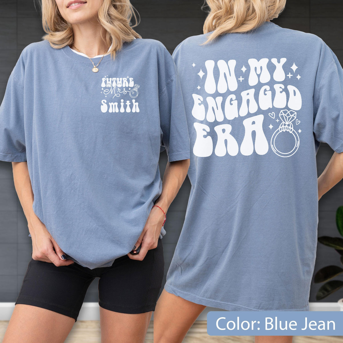 May include: A blue jean colored t-shirt featuring white text. The front left chest displays "Future Mrs. Smith" with a small ring icon. The back features large white text reading "IN MY ENGAGED ERA" accompanied by a graphic of a diamond engagement ring.