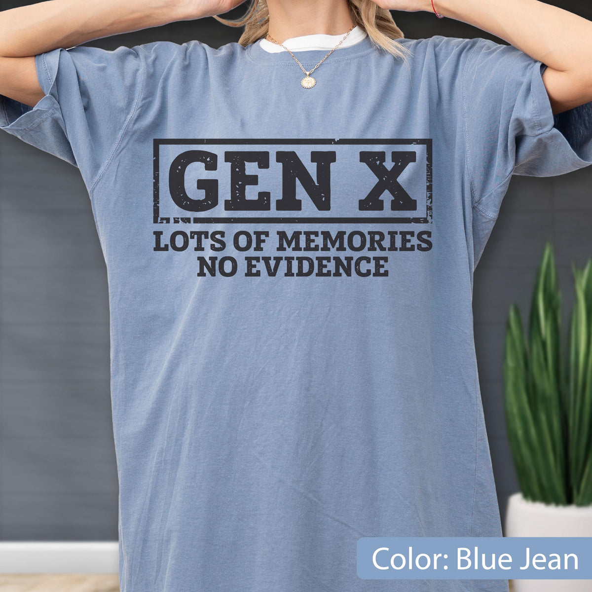 May include: A blue jean colored short-sleeve t-shirt featuring a black rectangular graphic with the text GEN X centered inside. Below the rectangle, the text reads LOTS OF MEMORIES NO EVIDENCE in a bold, distressed black font style.