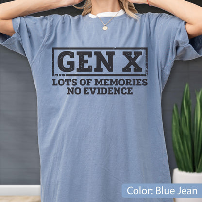 May include: A blue jean colored short-sleeve t-shirt featuring a black rectangular graphic with the text GEN X centered inside. Below the rectangle, the text reads LOTS OF MEMORIES NO EVIDENCE in a bold, distressed black font style.