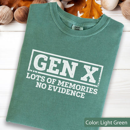 May include: A light green short-sleeve t-shirt featuring a white rectangular graphic with the text GEN X, LOTS OF MEMORIES, NO EVIDENCE. The shirt has a crew neckline and a Comfort Colors brand label visible on the inside of the collar area.