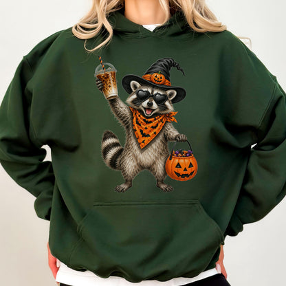 May include: A dark green hooded sweatshirt featuring a graphic of a raccoon wearing a black witch hat with a pumpkin, heart-shaped sunglasses, and an orange bat-patterned bandana. The raccoon holds a plastic cup and a jack-o'-lantern candy bucket.