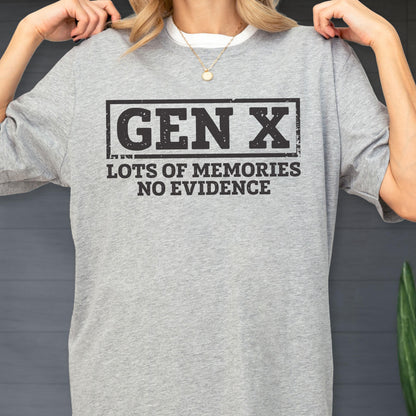 May include: A heather gray short-sleeve t-shirt featuring a black rectangular border containing the text GEN X in a bold, distressed font, followed by the text LOTS OF MEMORIES NO EVIDENCE in a matching black, distressed, sans-serif typeface.