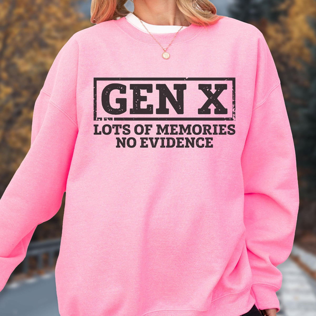 May include: A bright pink long-sleeve sweatshirt featuring a black rectangular graphic with the text GEN X in a bold, distressed font, followed by the text LOTS OF MEMORIES NO EVIDENCE in a matching black, sans-serif, distressed typeface.