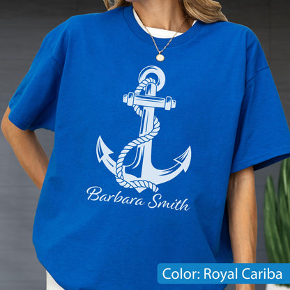 May include: A royal blue short-sleeve t-shirt featuring a large white graphic of a nautical anchor wrapped in a rope. The name Barbara Smith is printed in white script font below the anchor graphic. The shirt has a crew neckline.