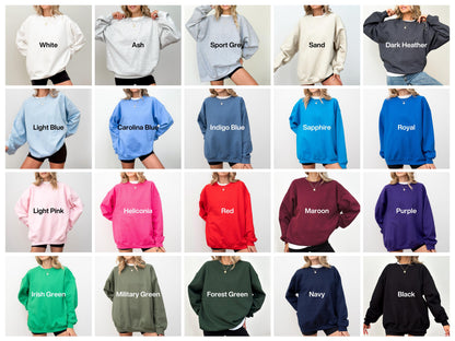 May include: A collection of twenty crewneck sweatshirts in various solid colors including white, ash, sport grey, sand, dark heather, light blue, carolina blue, indigo blue, sapphire, royal, light pink, heliconia, red, maroon, purple, irish green, military green, forest green, navy, and black.