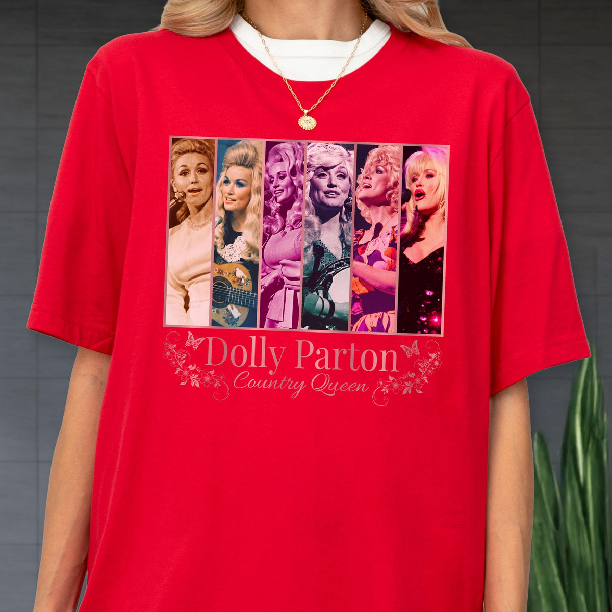 May include: A bright red short-sleeved t-shirt featuring a graphic print of six vertical panels showing various portraits of Dolly Parton. Below the images, the text reads Dolly Parton Country Queen, accompanied by small butterfly and floral illustrations.