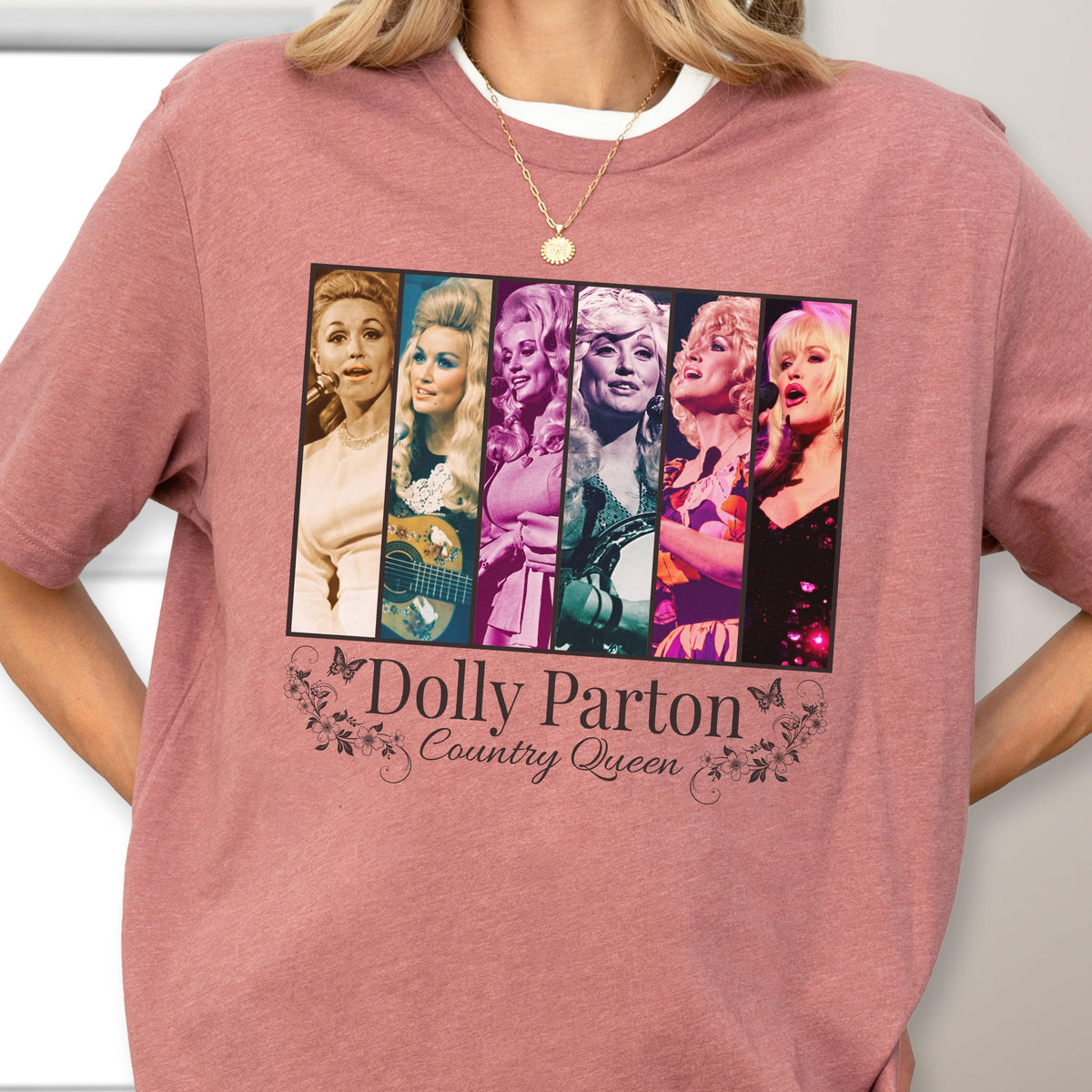 May include: A dusty rose short-sleeve t-shirt featuring a rectangular graphic with six vertical panels showing different portraits of Dolly Parton. Below the graphic, the text reads Dolly Parton Country Queen with small butterfly and floral accents.