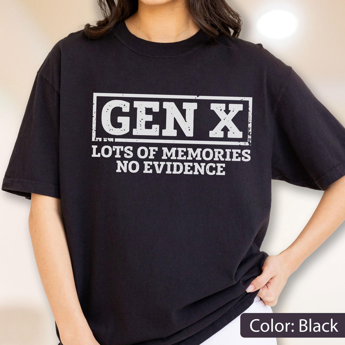May include: A black short-sleeved t-shirt featuring a white rectangular graphic with the text "GEN X" in large block letters, followed by the text "LOTS OF MEMORIES NO EVIDENCE" in a smaller font. The design has a distressed, weathered texture.