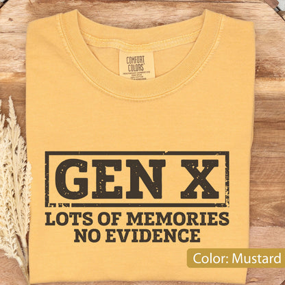 May include: A mustard yellow t-shirt with a crew neckline and a Comfort Colors brand label at the inner collar. The front features a black rectangular graphic containing the text GEN X, followed by the text LOTS OF MEMORIES NO EVIDENCE.