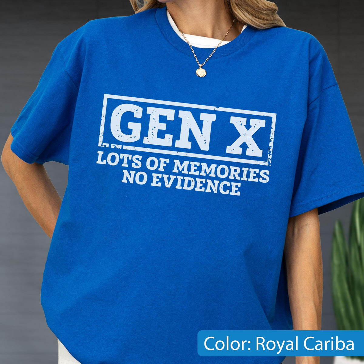 May include: A royal blue short-sleeve t-shirt featuring a white rectangular graphic with distressed edges. The text inside reads GEN X, followed by the words LOTS OF MEMORIES NO EVIDENCE in a bold, white, sans-serif font centered on the chest.