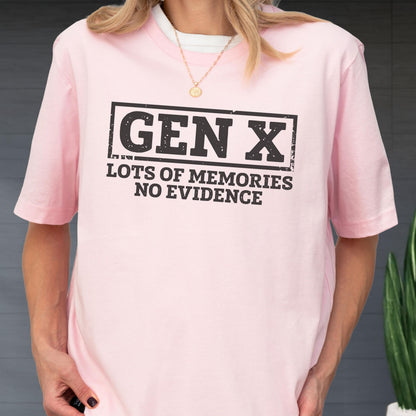 May include: A light pink short-sleeved t-shirt featuring a black rectangular graphic with the text "GEN X" in a bold, distressed font, followed by the text "LOTS OF MEMORIES NO EVIDENCE" in a smaller, matching black distressed typeface.