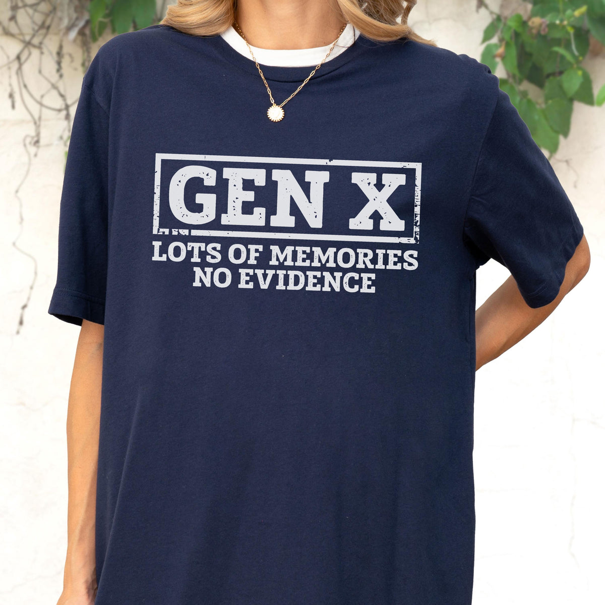 May include: A navy blue short-sleeve t-shirt featuring a white rectangular graphic with the text GEN X in a distressed font, followed by the text LOTS OF MEMORIES NO EVIDENCE in a matching distressed white font on the chest area.
