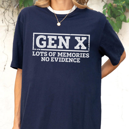 May include: A navy blue short-sleeve t-shirt featuring a white rectangular graphic with the text GEN X in a distressed font, followed by the text LOTS OF MEMORIES NO EVIDENCE in a matching distressed white font on the chest area.