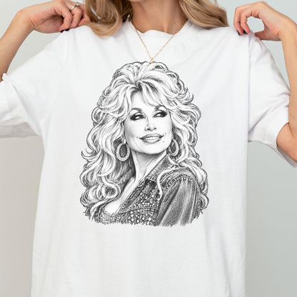 May include: A white t-shirt featuring a detailed black and white pencil-style sketch of a person with voluminous, wavy hair, wearing large hoop earrings and a textured jacket. The illustration is centered on the chest of the garment.