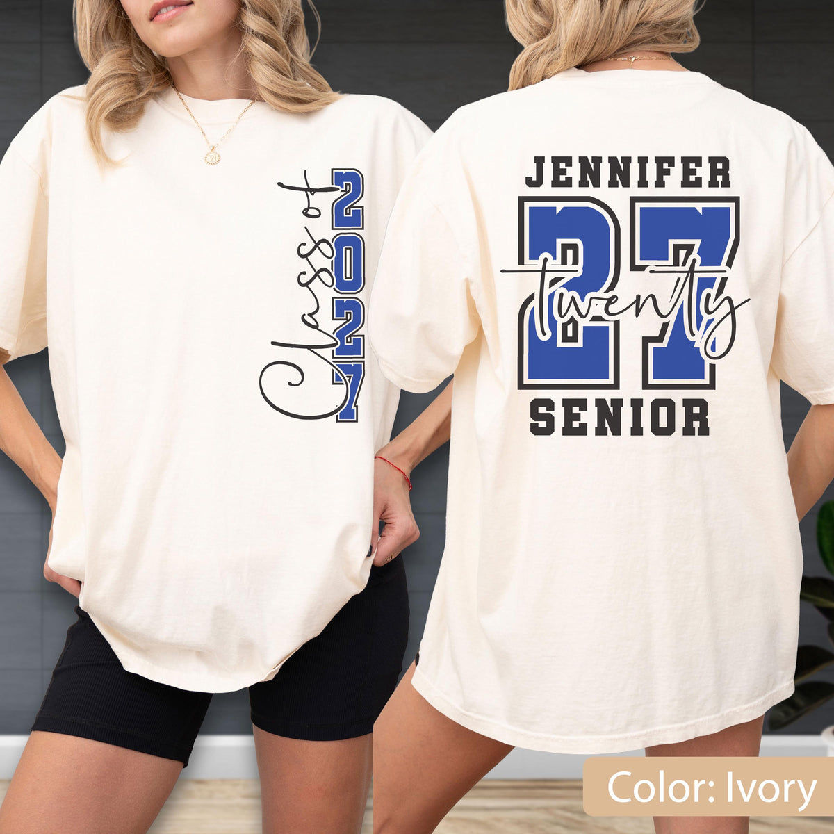 May include: An ivory t-shirt featuring a graphic design. The front displays the text Class of 2027 in black and blue. The back features the name Jennifer, the number 27 in large blue and black font, the word twenty in script, and the word Senior.