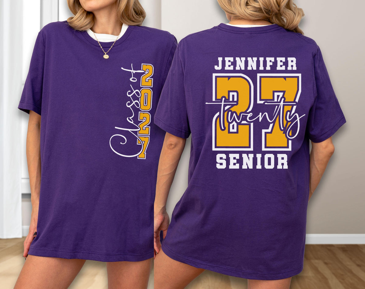 May include: A purple t-shirt featuring a white and yellow graphic on the front that reads Class of 2027. The back of the shirt displays the name Jennifer in white, the large yellow number 27, the word twenty in script, and the word SENIOR in white.