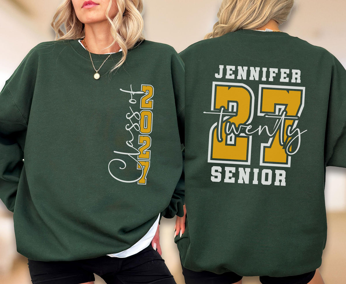 May include: A dark green crewneck sweatshirt featuring white and gold graphics. The front displays vertical text reading Class of 2027. The back features the name Jennifer, the large number 27, the word twenty in script, and the word SENIOR.