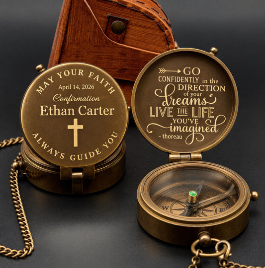 a personalized compass with a message engraved on it, placed on a dark surface next to a wooden box.