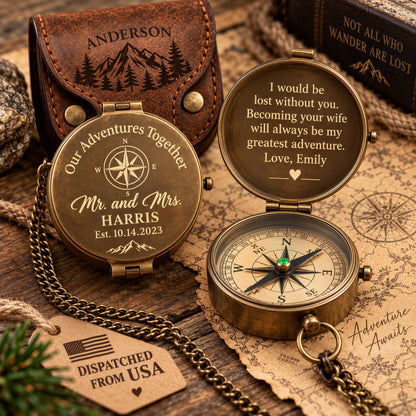 a personalized compass with a heartfelt message engraved on it, placed on a wooden surface alongside other items such as a leather pouch and a map.