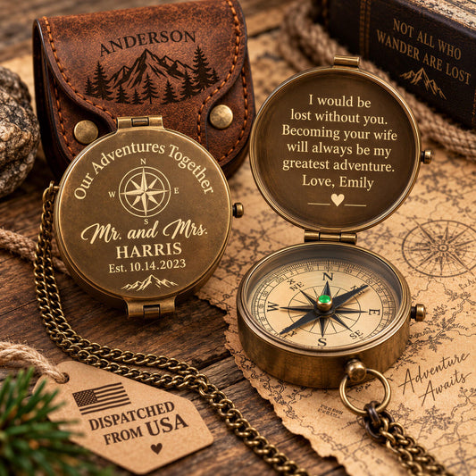 a personalized compass with a heartfelt message engraved on it, placed on a wooden surface alongside other items such as a leather pouch and a map.