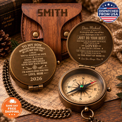 a personalized compass with a heartfelt message engraved on it, placed on a wooden surface alongside a map and a book.