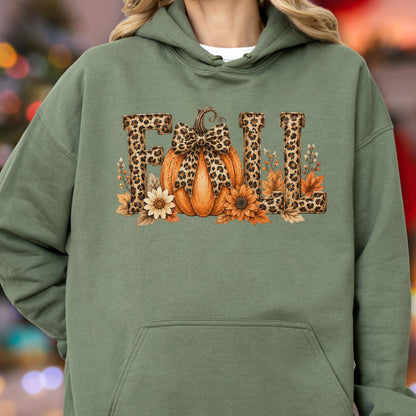 May include: An olive green hooded sweatshirt featuring a graphic print of the word FALL. The letters have a brown leopard print pattern. An orange pumpkin with a leopard print bow sits in the center, surrounded by autumn leaves and flowers.