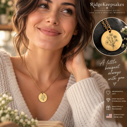 A woman wearing a gold necklace with a pendant featuring a flower design, smiling and looking to the side.
