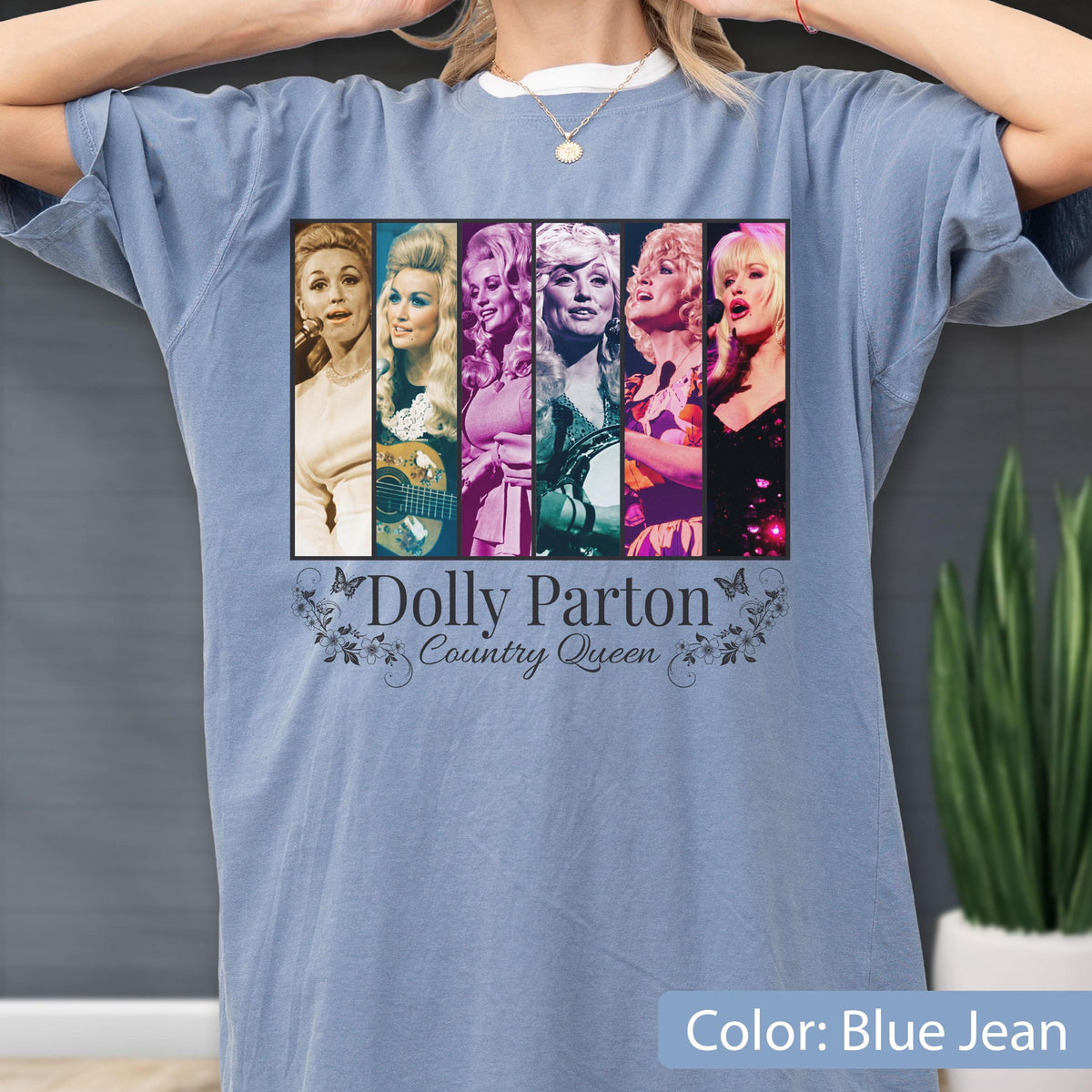 May include: A blue jean colored t-shirt featuring a graphic print of six vertical panels displaying various portraits of Dolly Parton. Below the images, the text reads Dolly Parton Country Queen, surrounded by decorative floral and butterfly motifs.