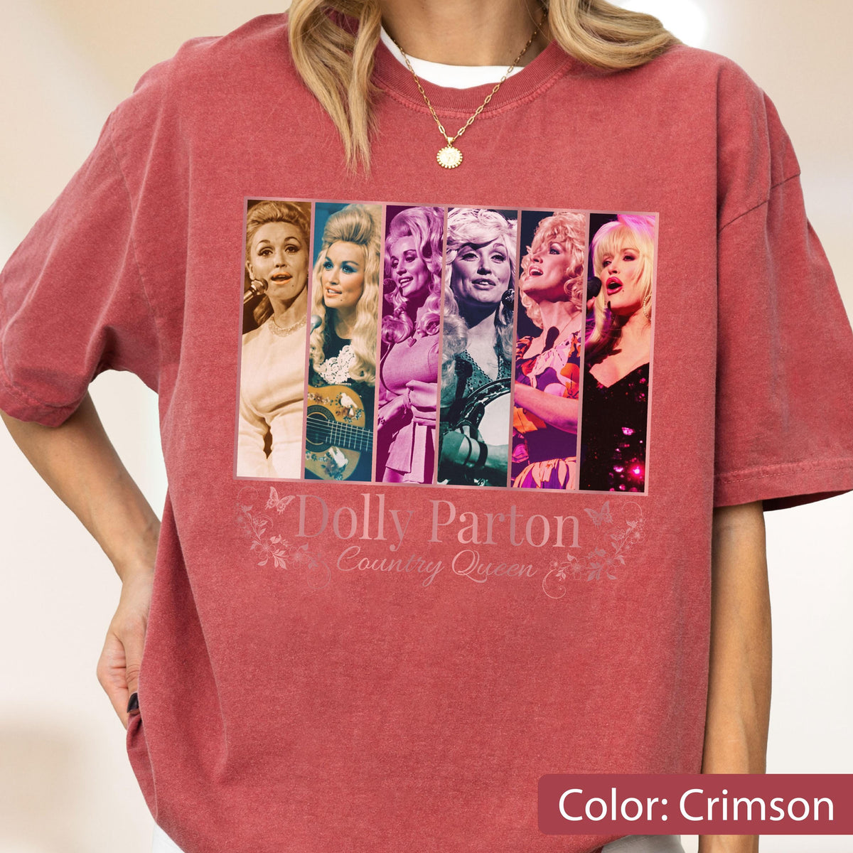 May include: A crimson short-sleeve t-shirt featuring a graphic print of six vertical panels displaying various portraits of Dolly Parton. Below the images, the text reads Dolly Parton Country Queen in a stylized font with small butterfly illustrations.