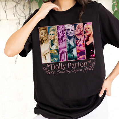 May include: A black short-sleeve t-shirt featuring a rectangular graphic with six distinct photographic panels of Dolly Parton. Below the images, the text reads Dolly Parton Country Queen, surrounded by decorative floral and butterfly line art.