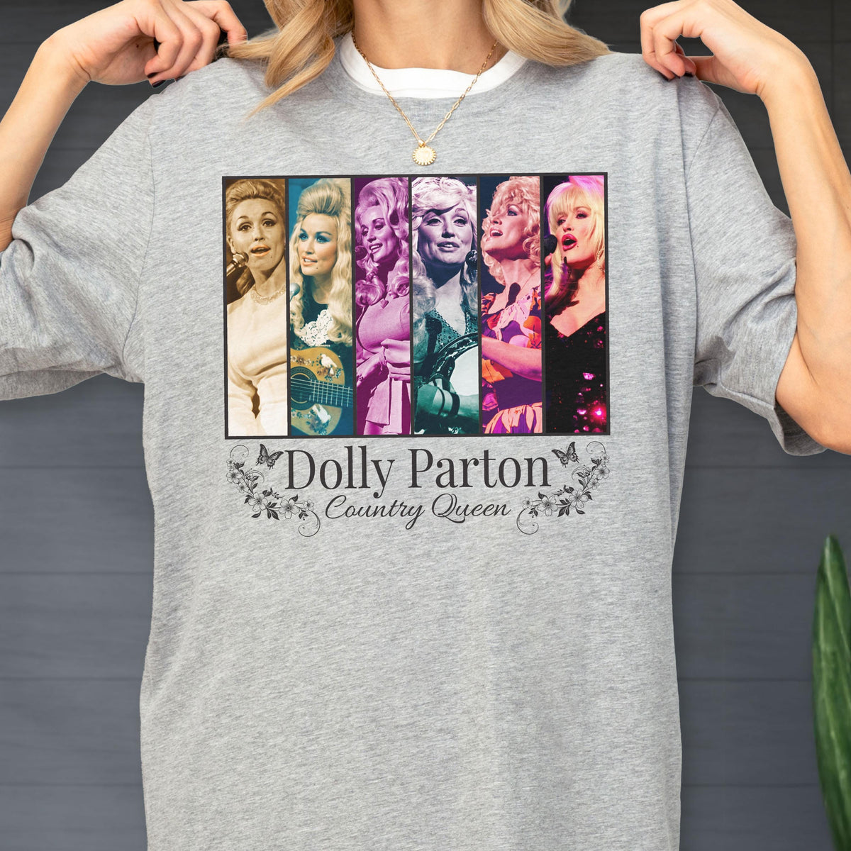 May include: A heather gray t-shirt featuring a rectangular graphic with six vertical panels displaying various portraits of Dolly Parton. Below the graphic, the text reads Dolly Parton Country Queen, surrounded by small floral and butterfly illustrations.