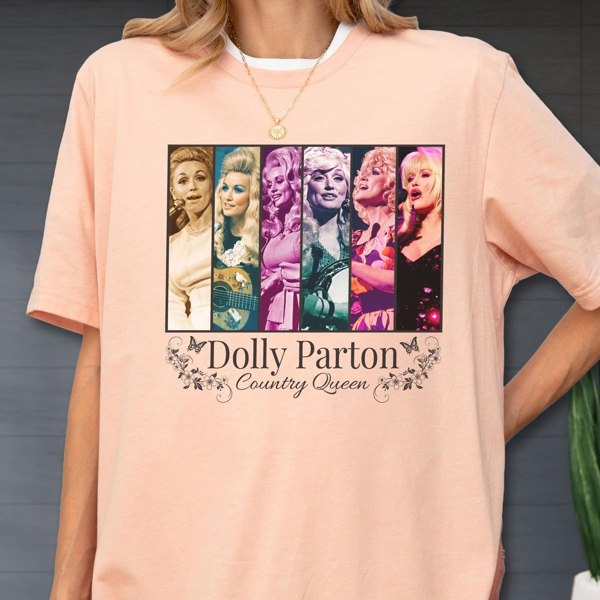 May include: A peach-colored t-shirt featuring a graphic print of six vertical panels showing Dolly Parton in various stages of her career. Below the images, the text reads Dolly Parton Country Queen, framed by small floral and butterfly illustrations.