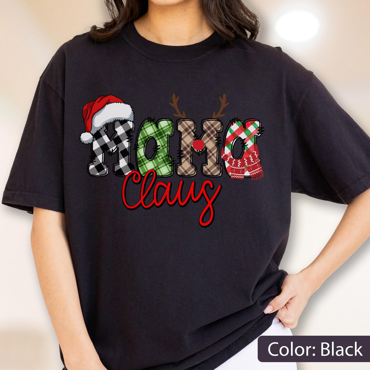 May include: Black t-shirt with the words "Ho Ho Claus" in a festive design. The letters are decorated with a Santa hat, reindeer antlers, plaid patterns, and a scarf. The word "Claus" is in red script.
