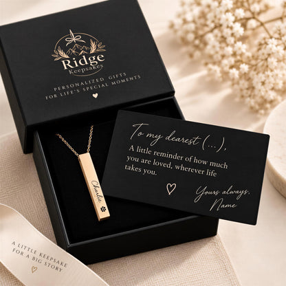 A personalized gift box containing a necklace with a nameplate and a card with a heartfelt message.