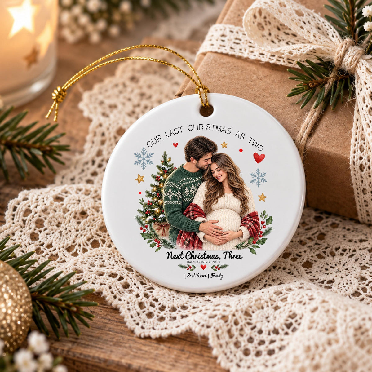 May include: A round white ceramic ornament featuring a printed photograph of a couple embracing, with the text "OUR LAST CHRISTMAS AS TWO" and "NEXT CHRISTMAS, THREE" along with "BABY COMING 2023" and "[Last Name] Family" printed in black ink.
