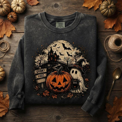 May include: A charcoal grey crewneck sweatshirt featuring a graphic print of a jack-o'-lantern, a ghost wearing a witch hat holding a mug labeled BOO, a haunted house, and a wooden sign that reads SPOOKY VIBES under a full moon with bats.
