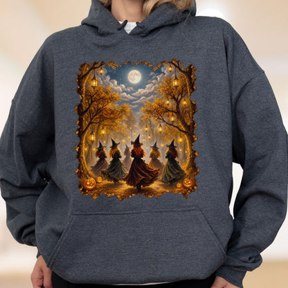 May include: A dark heather gray hooded sweatshirt featuring a central graphic print of several figures in pointed hats dancing in a forest at night. The scene includes glowing lanterns hanging from autumn trees, a full moon, and orange pumpkins.