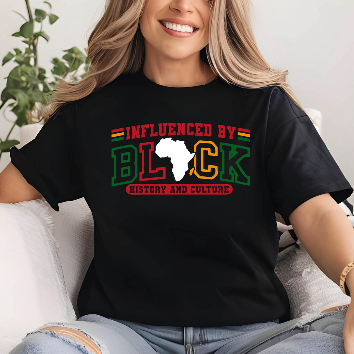 May include: Black t-shirt with a graphic print of a white outline of the continent of Africa with the text "INFLUENCED BY BLACK HISTORY AND CULTURE" in green, red, and yellow.